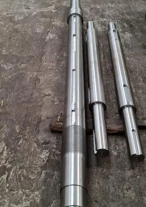 Three machined steel shafts with keyways and threaded section
