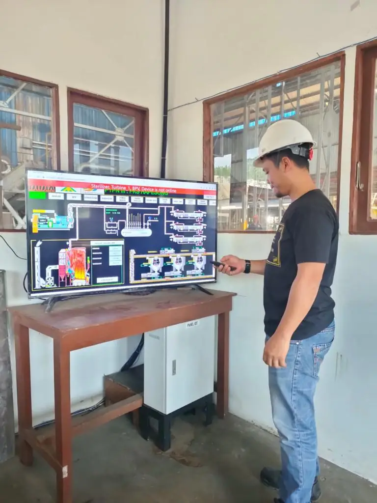 Operator beside a customized SCADA monitoring screen