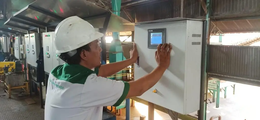 Technician operating an automation control panel