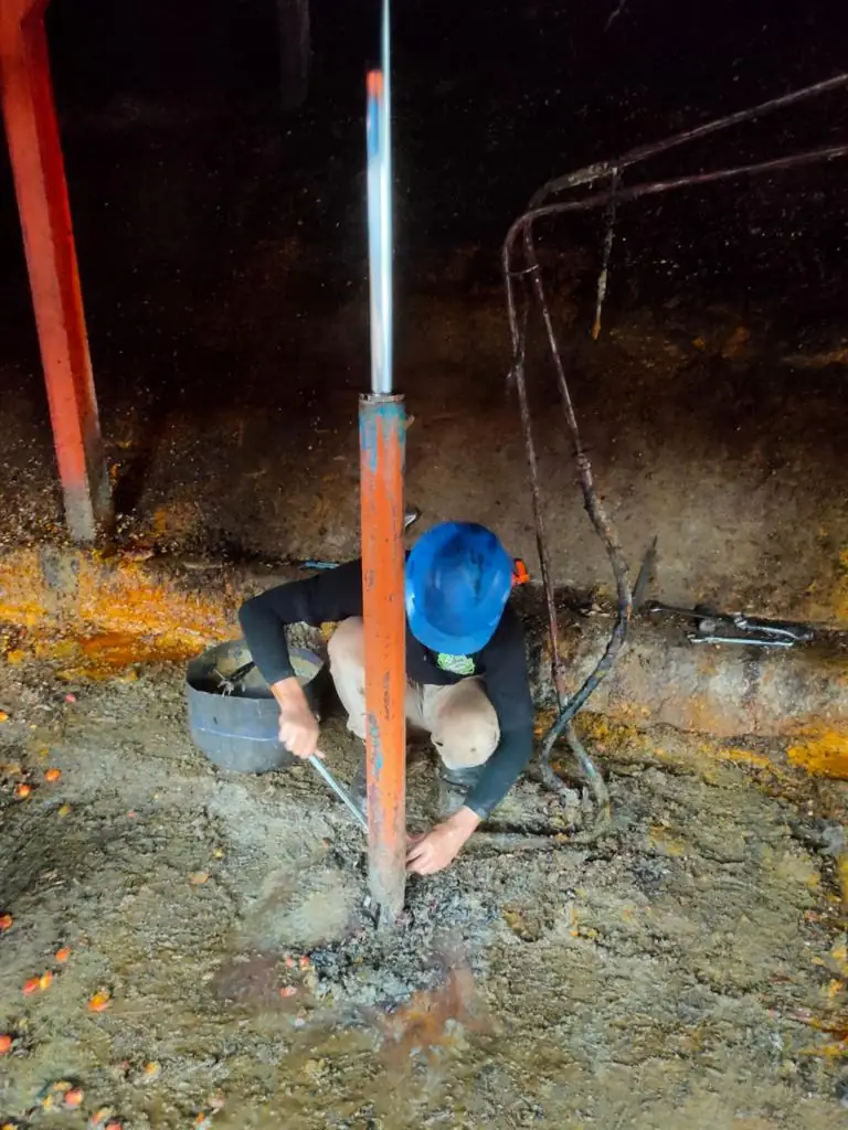 Technician maintaining a hydraulic cylinder