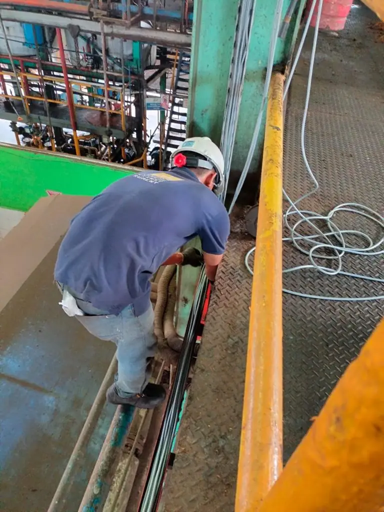 Technician inspecting a conveyor system