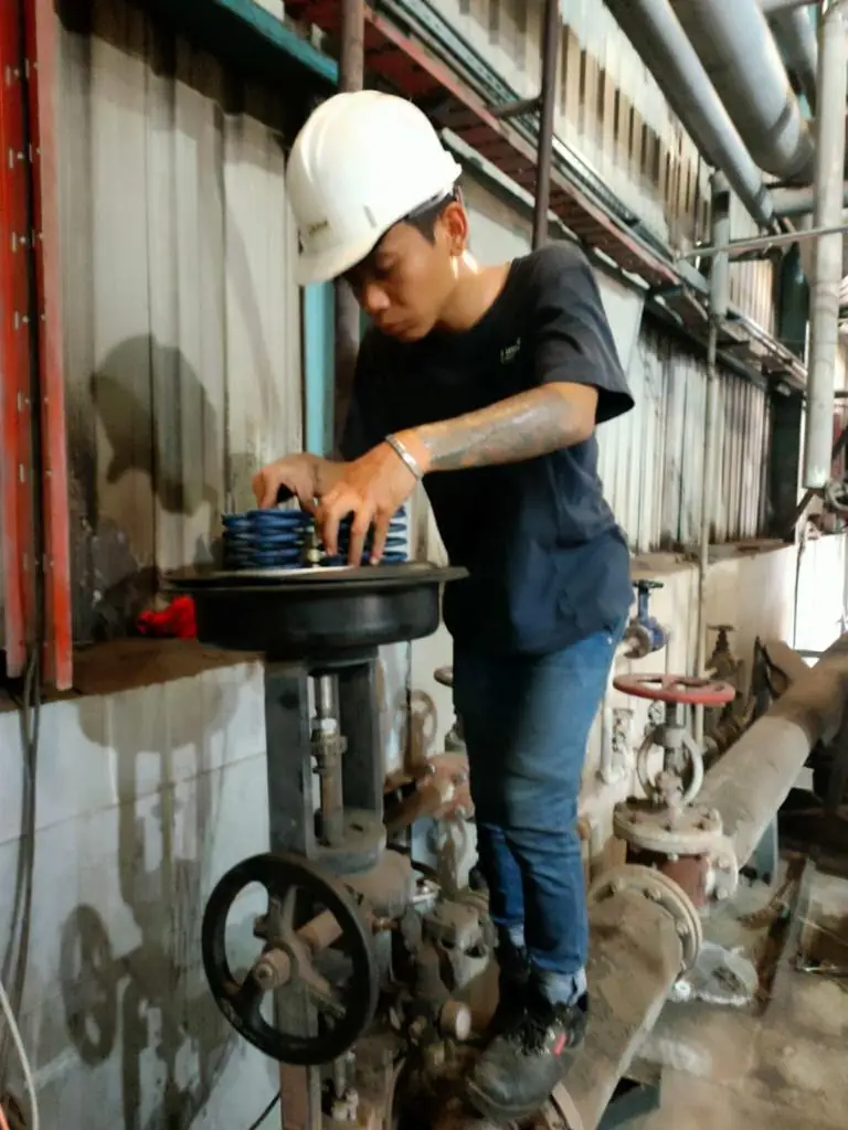 Technician servicing a control valve