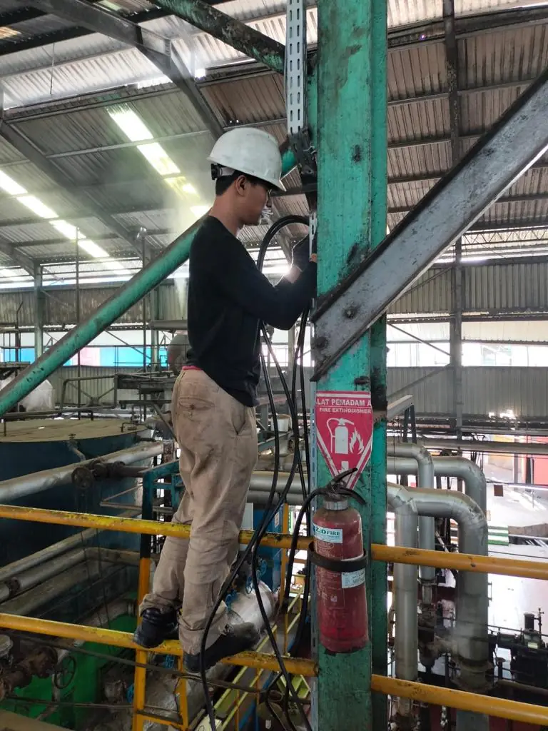 Technician working on a plant structure